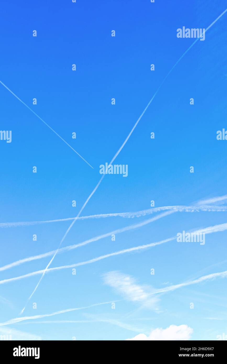 Contrails patterns of high flying aircraft against a deep blue sky over ...