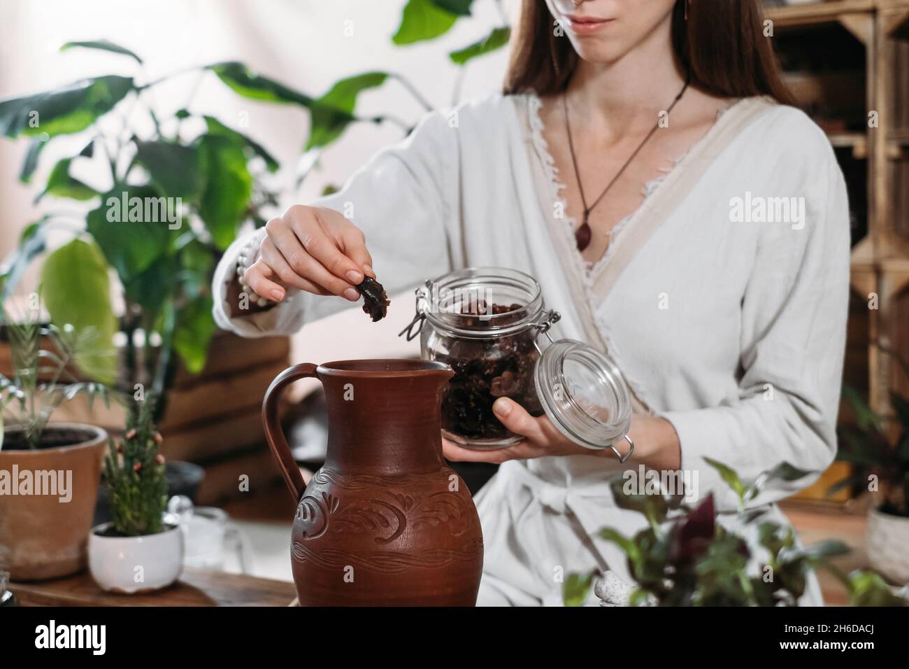 Cocoa Personal Ritual Cacao ceremony in atmospheric space with green plants and candles ...