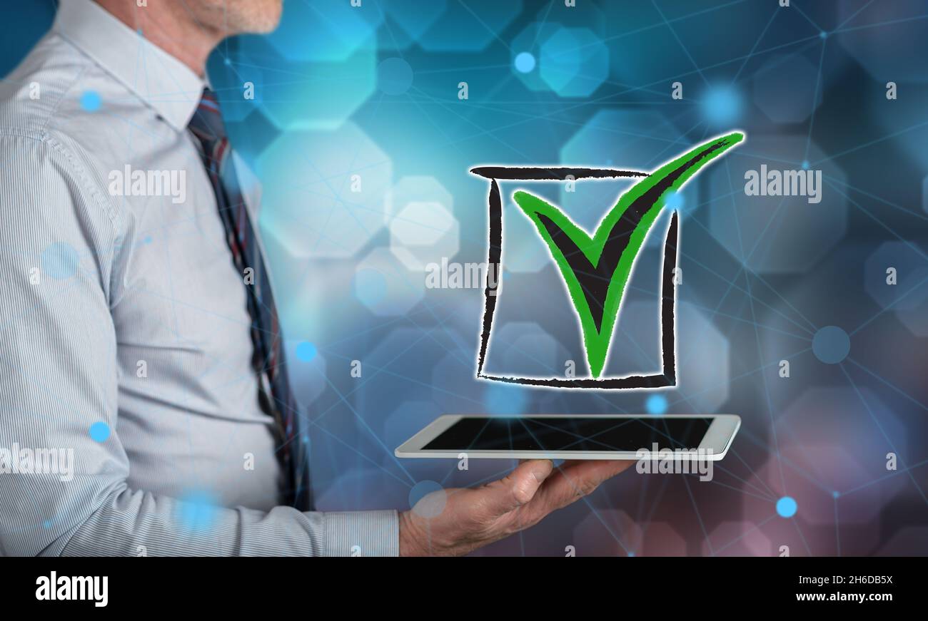 Validation concept above a tablet held by a man Stock Photo