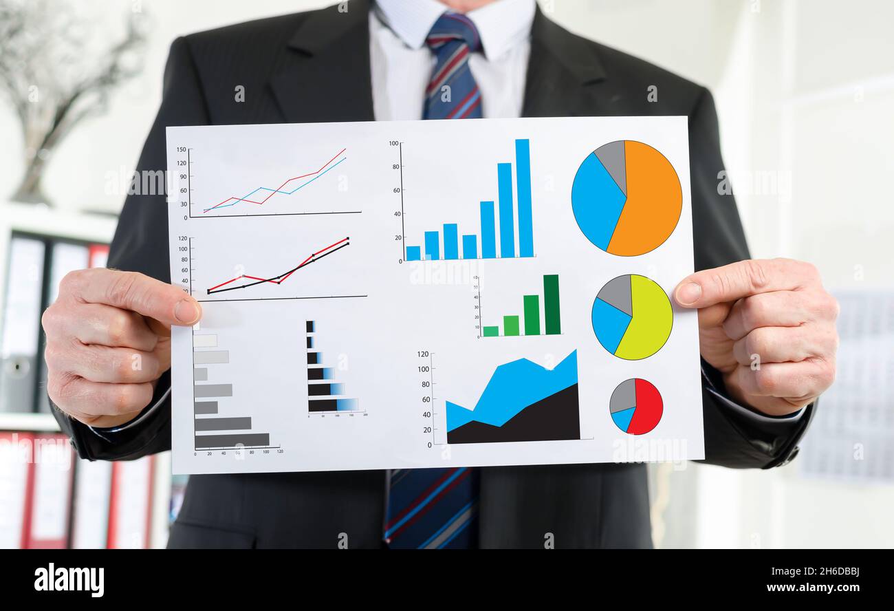 Paper showing graphical analysis concept held by a businessman Stock ...