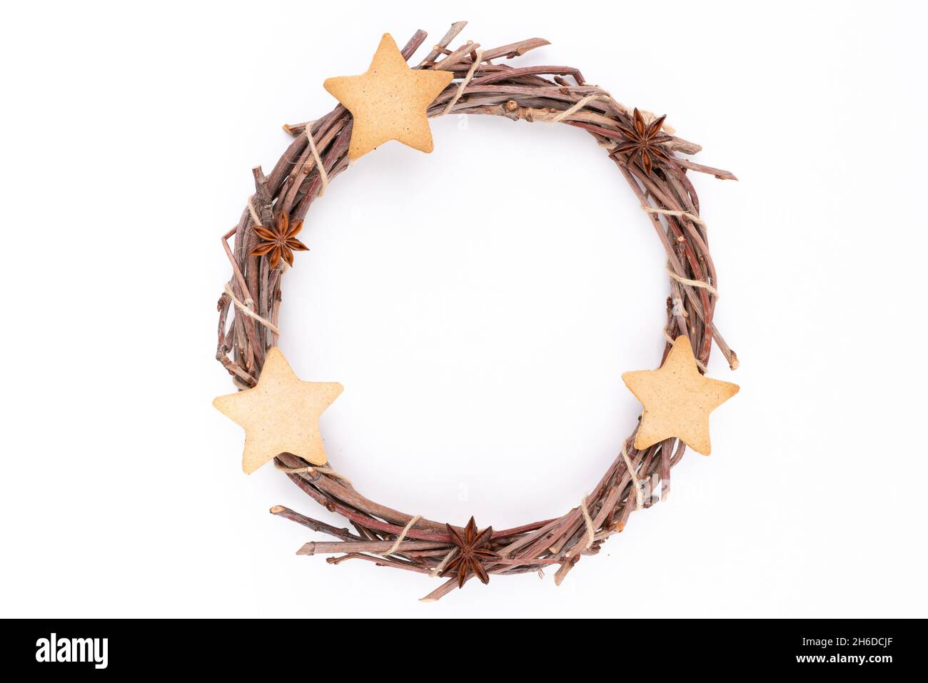 Detail top studio shot of handmade, dry Christmas wreath with gingerbread stars and star anises isolated on white background. Christmas concept Stock Photo