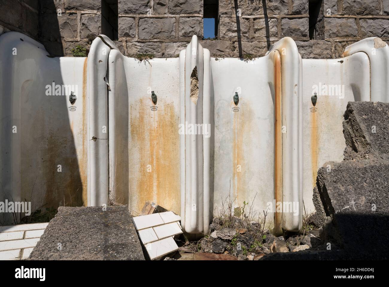 Birnbeck Pier, Birnbeck Island, Weston-Super-Mare, Somerset, 2018. Detail of stained and damaged urinals in the gentlemen's toilets on the derelict pier, 2018. Stock Photo