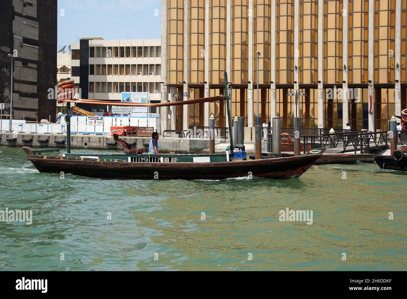 traditional ship and cladding of Emirates Bank at Dubai Creek, United Arab Emirates, Dubai Stock Photo