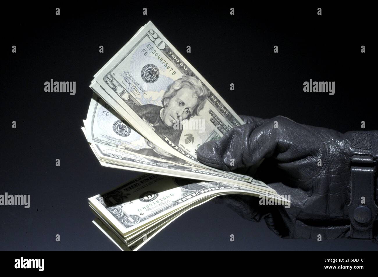 20 dollar bill in a hand in leather glove, USA Stock Photo