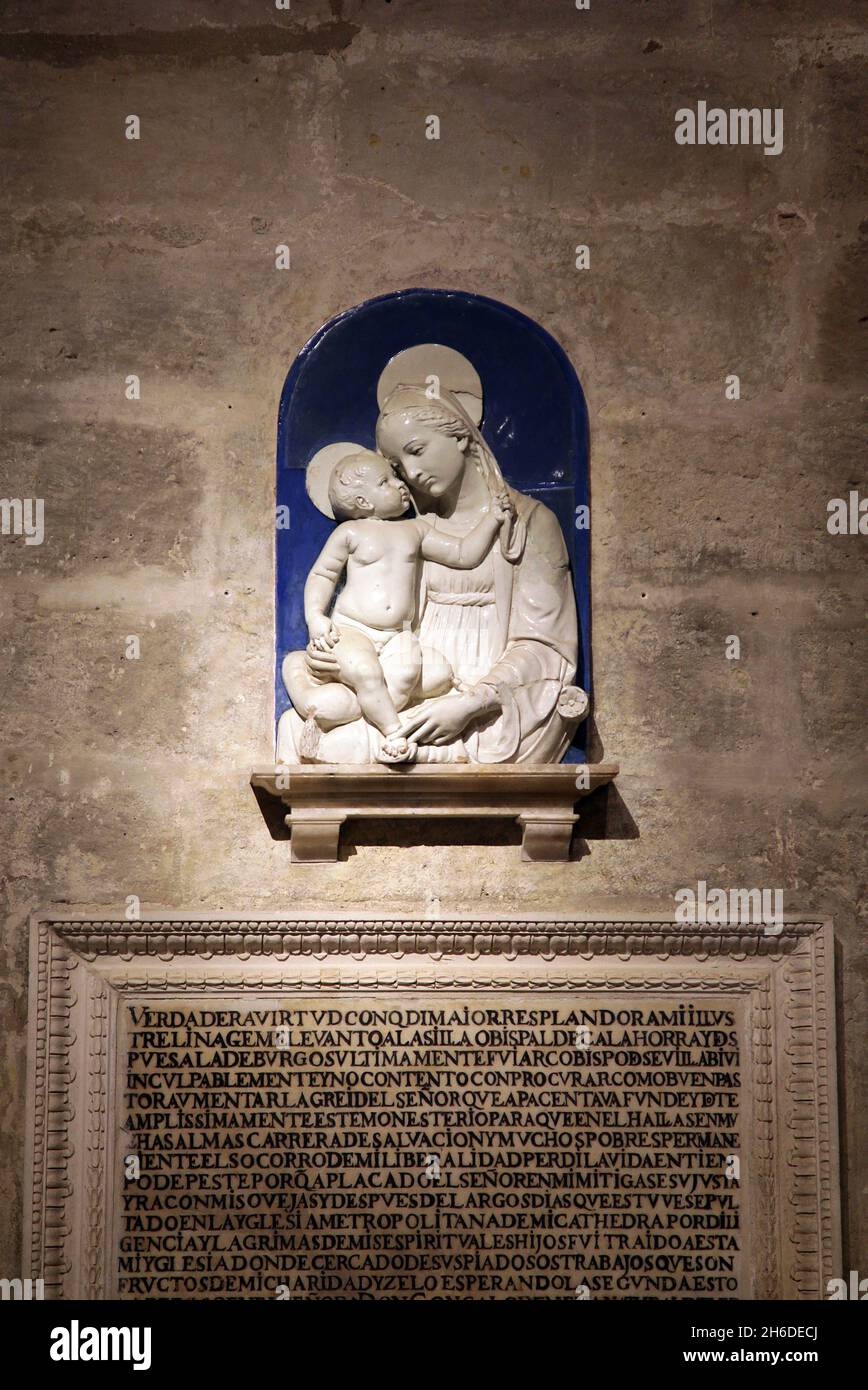 Ceramic relief of Our Lady of the Cushion (15th century) Andrea della Robbia workshop,at the Capilla de Santiago,The Seville Cathedral Stock Photo