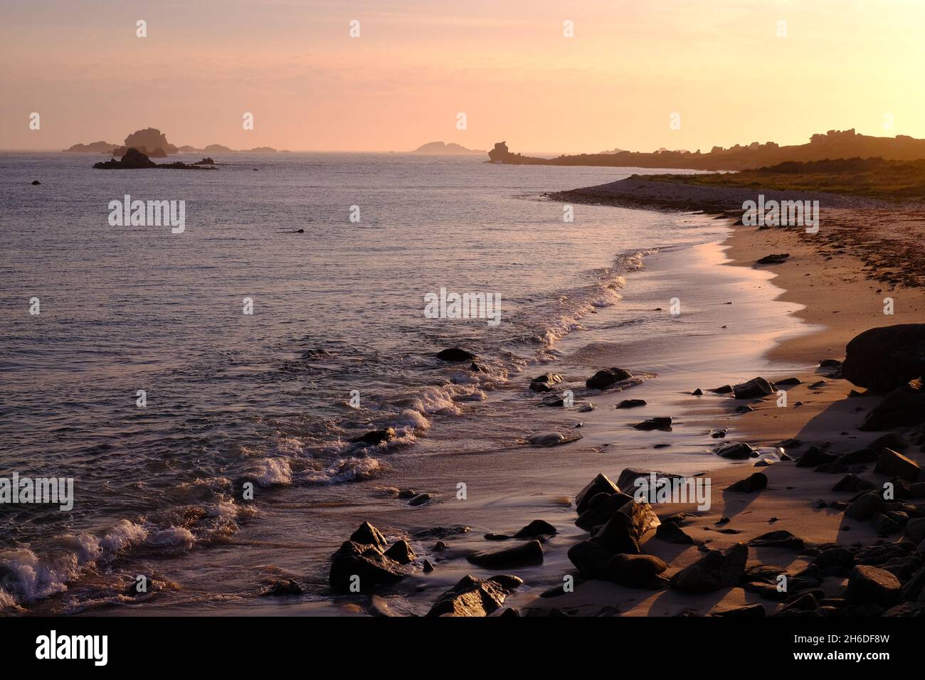Rushy Bay, Bryher, at sunset, showing Droppy Nose Point in the distance Stock Photo