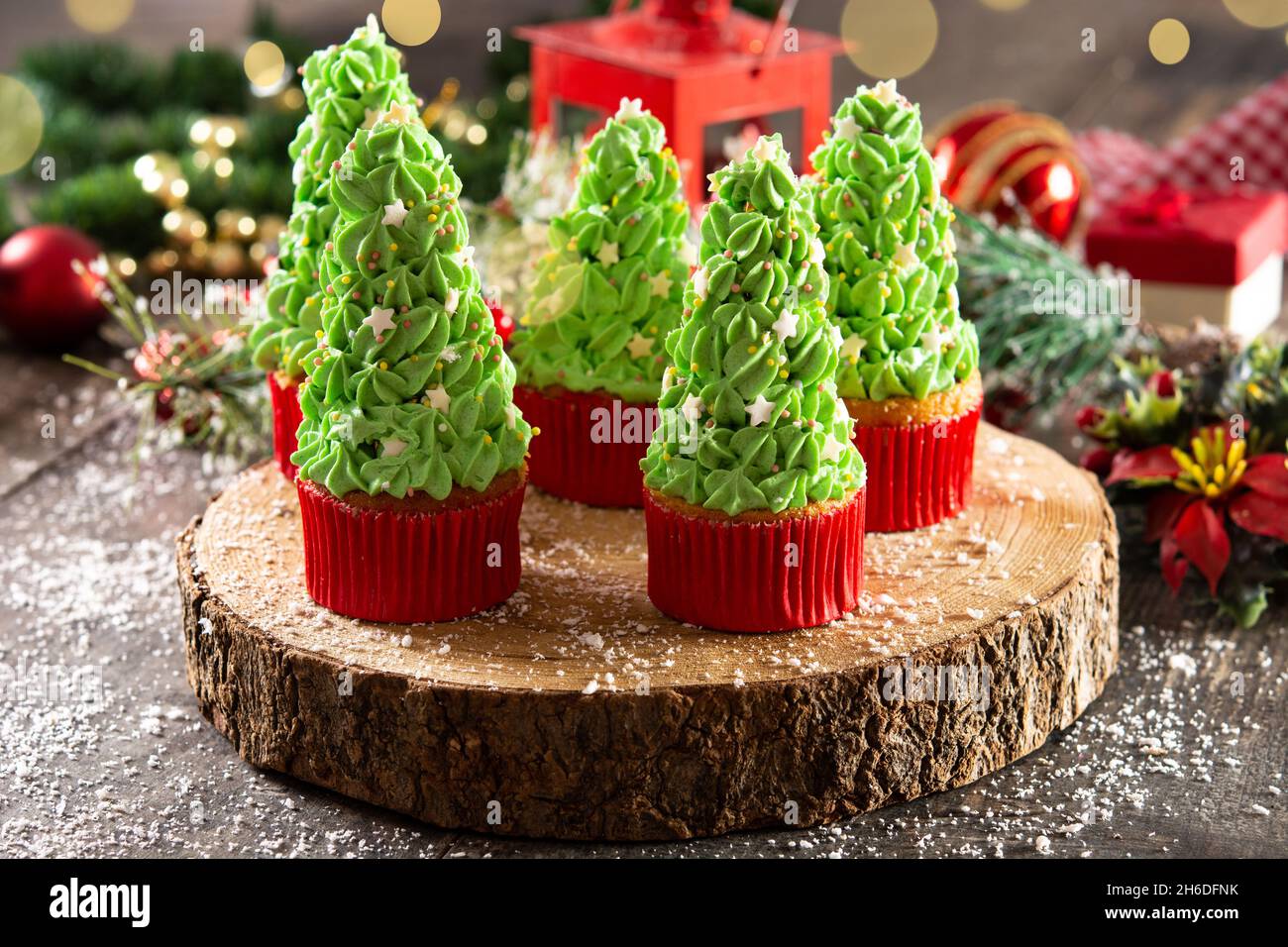 Christmas tree cupcakes on wooden table Stock Photo