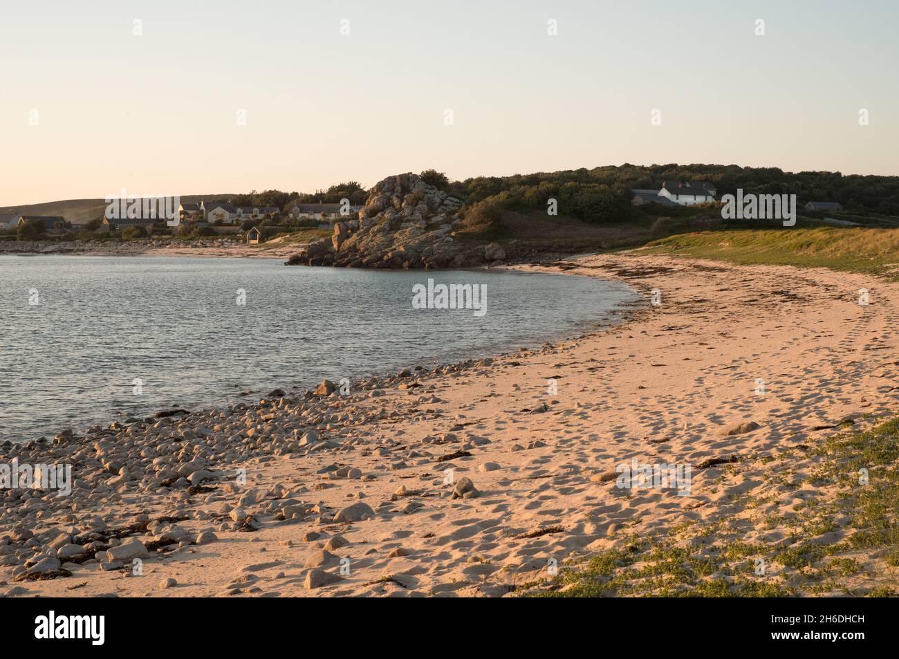 Beach on Bryher, Isles of Scilly, showing Hillside Farm in the distance Stock Photo