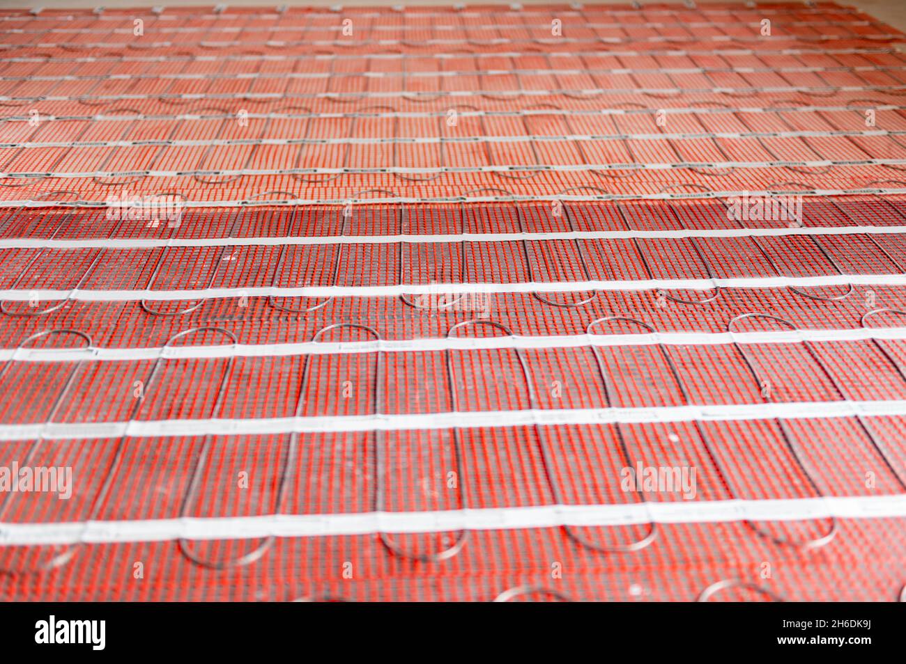 Process of instalation of electric underfloor heating mats Stock Photo