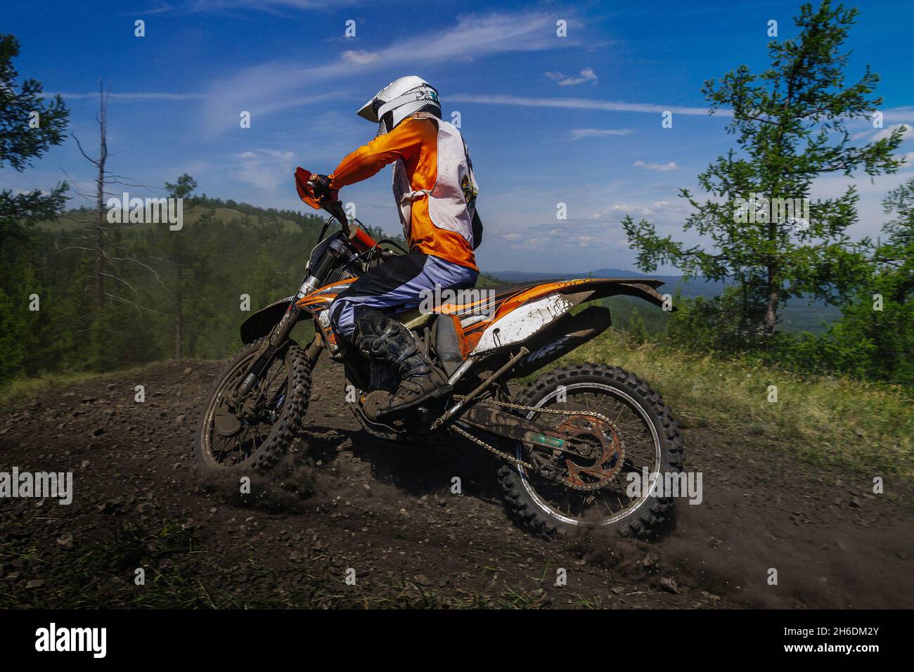 enduro motorcycle racer riding dusty trail Stock Photo Alamy