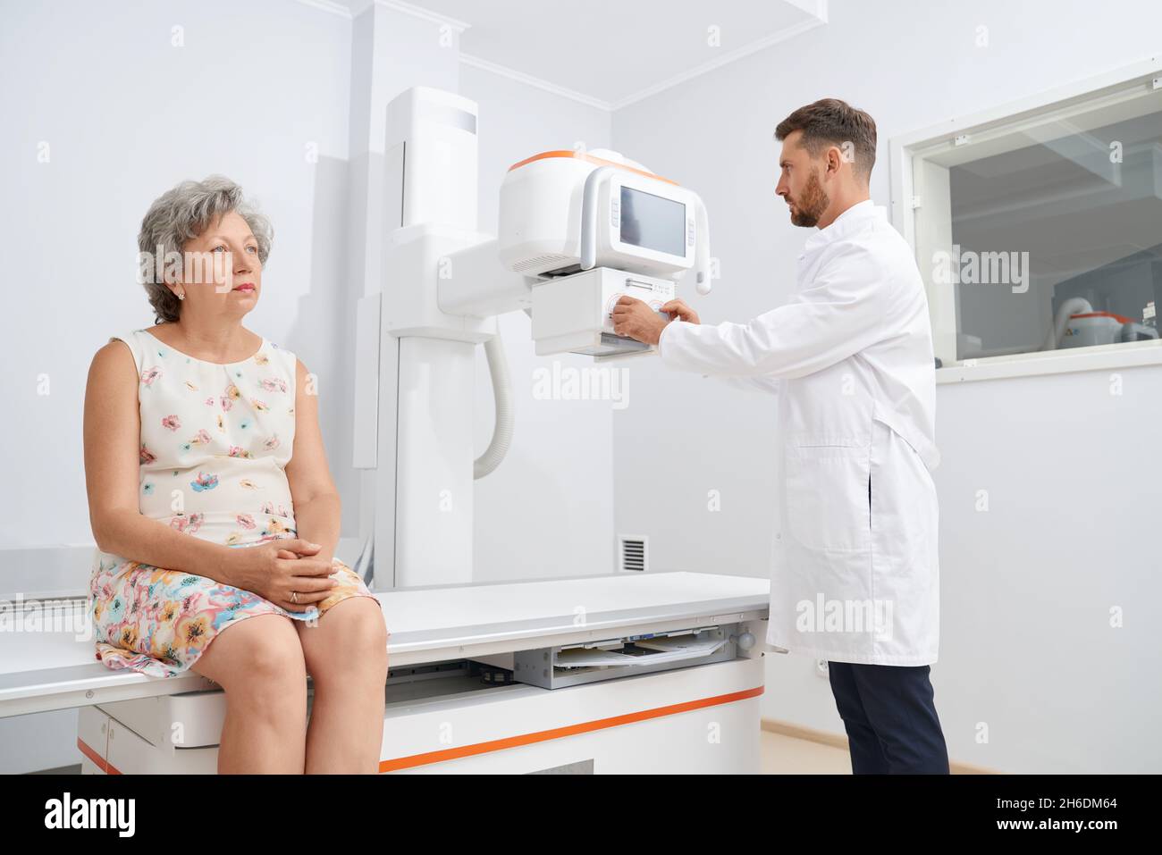 Sadly woman wearing floral dress waiting for procedure of ultrasound