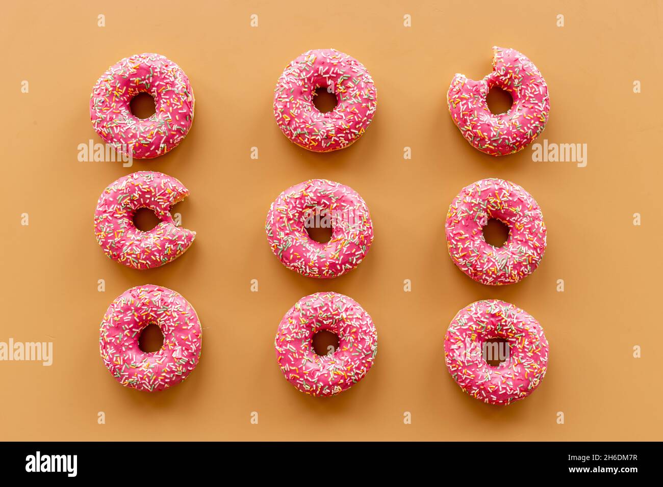 Pink frosted donuts with colorful sprinkles. Bakery background Stock ...
