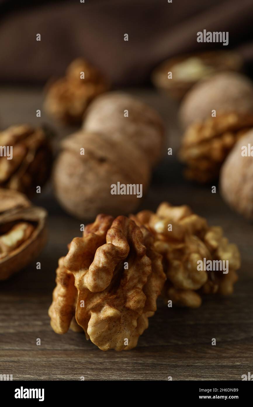 Walnuts with kitchen towel on wooden background Stock Photo