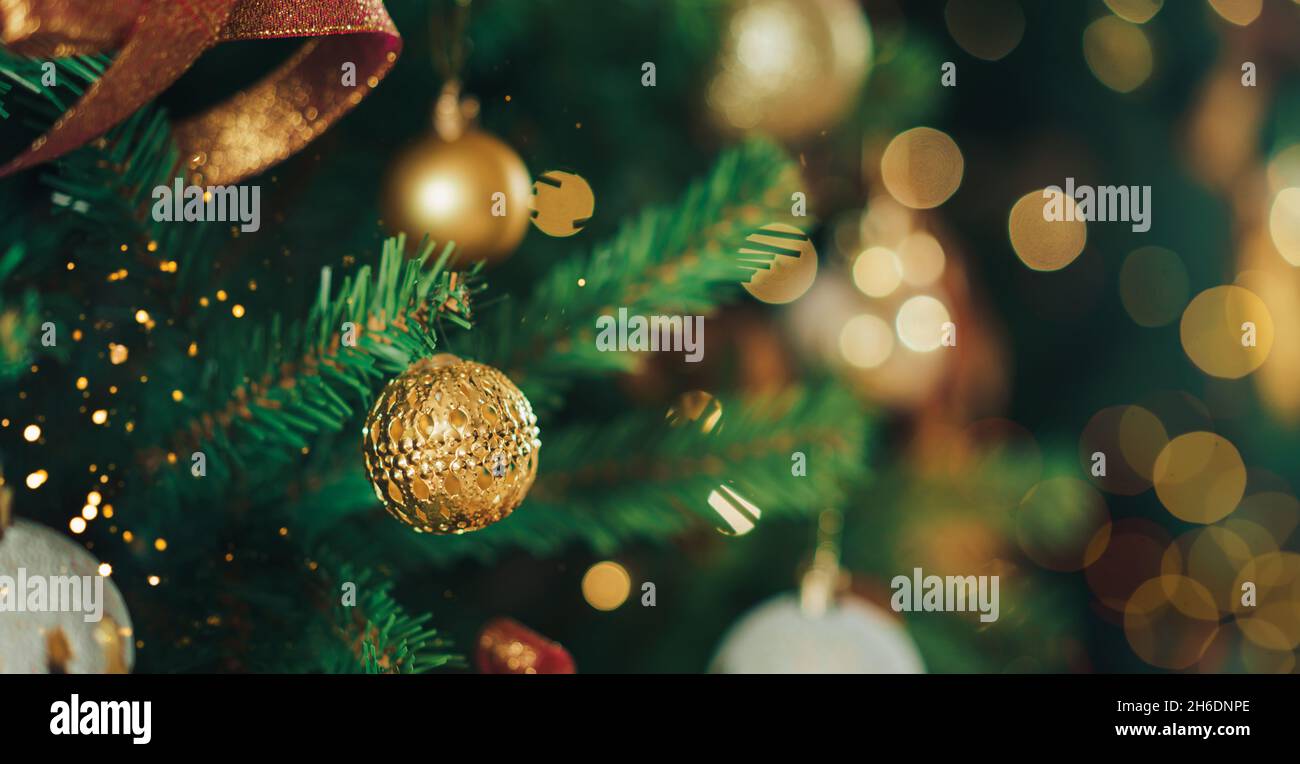 Artificial Christmas tree branch with baubles and garland Stock Photo