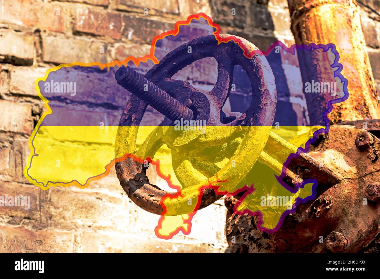 Old rusty gas control valve on the wall. Gas tap on a contour map on the flag of Ukraine. The gas transportation system of Ukraine is malfunctioning. Stock Photo