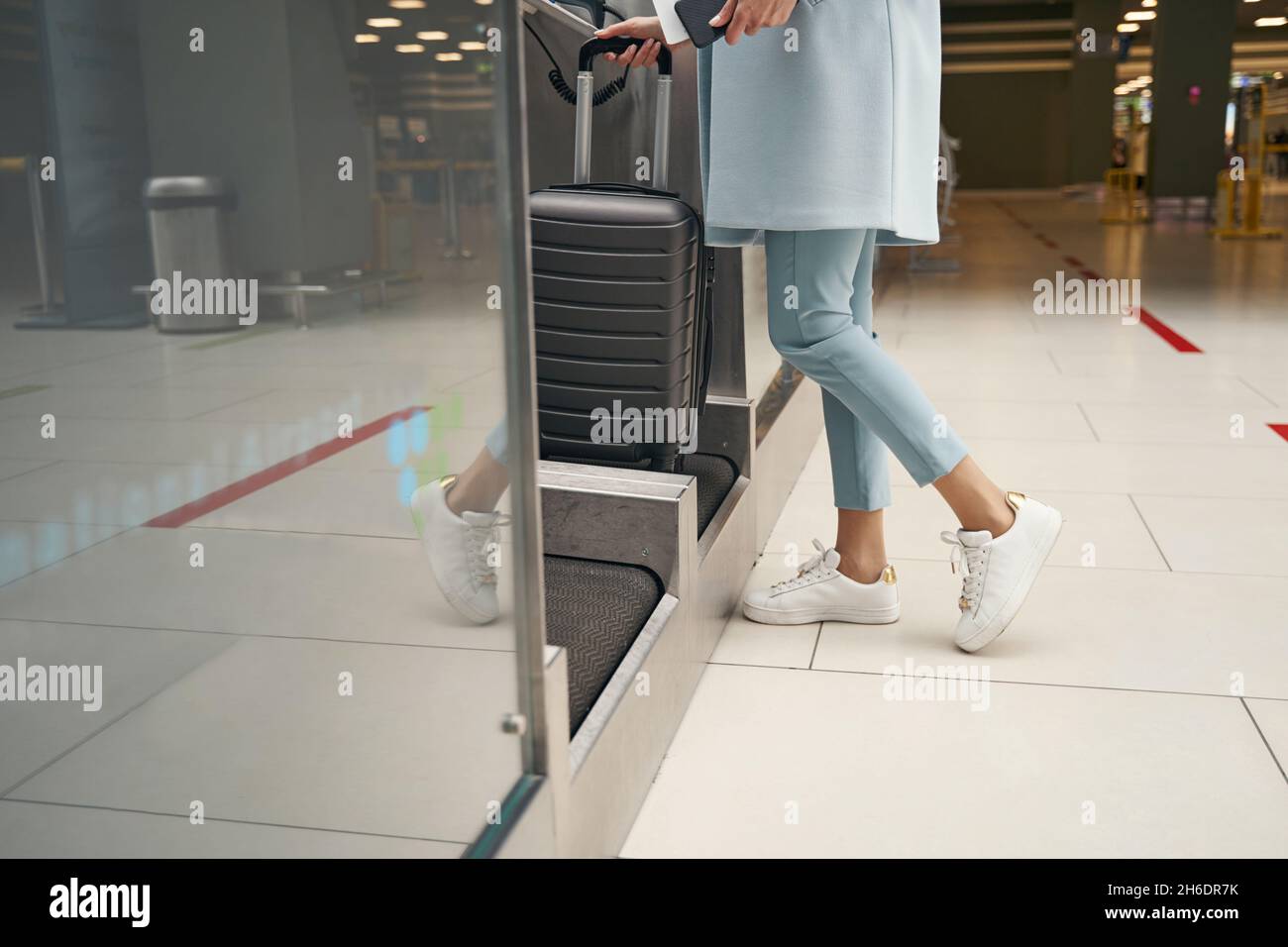 Air traveler using selfservice luggage dropoff unit Stock Photo Alamy