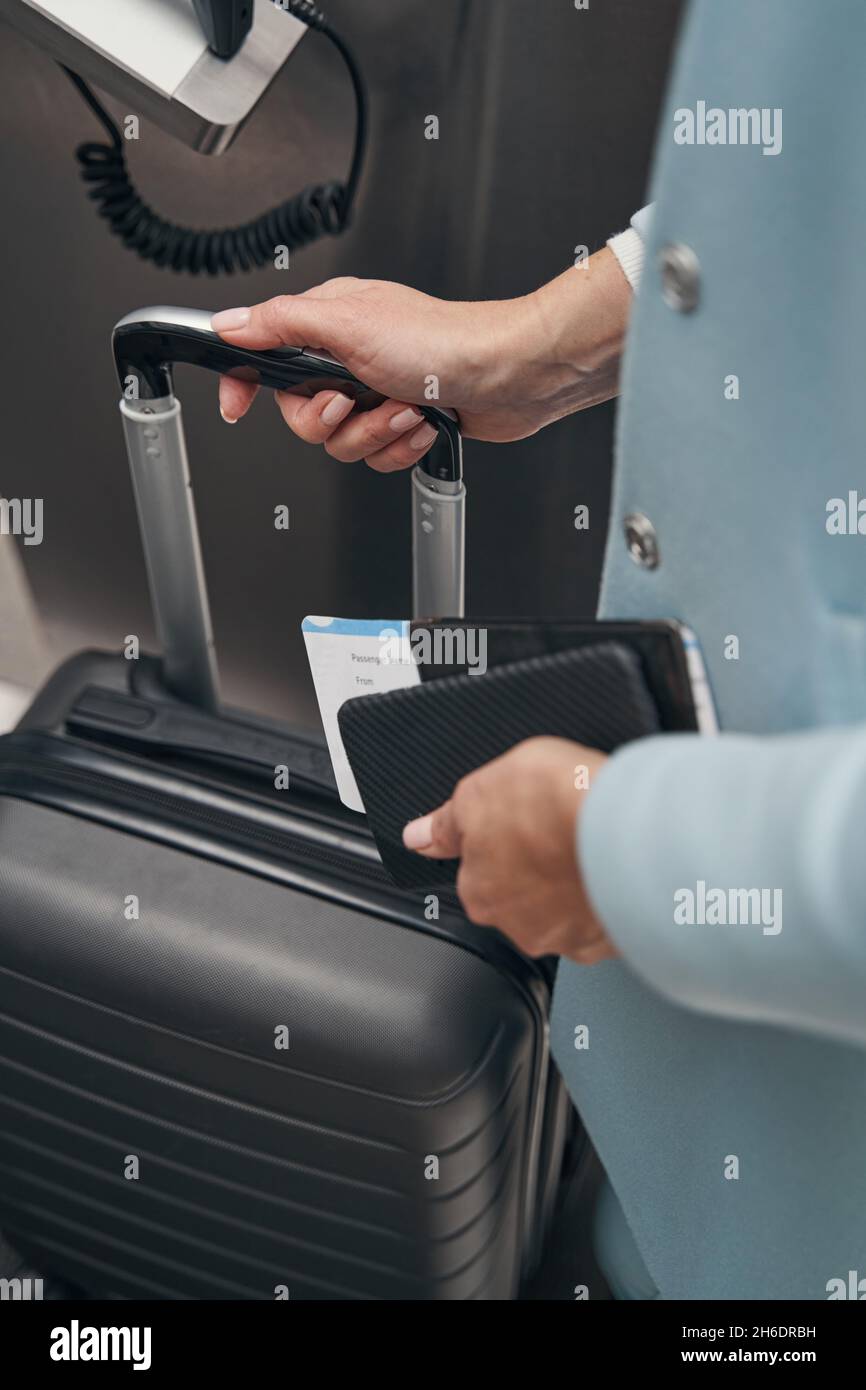 Passenger dropping off her baggage at airport terminal Stock Photo Alamy
