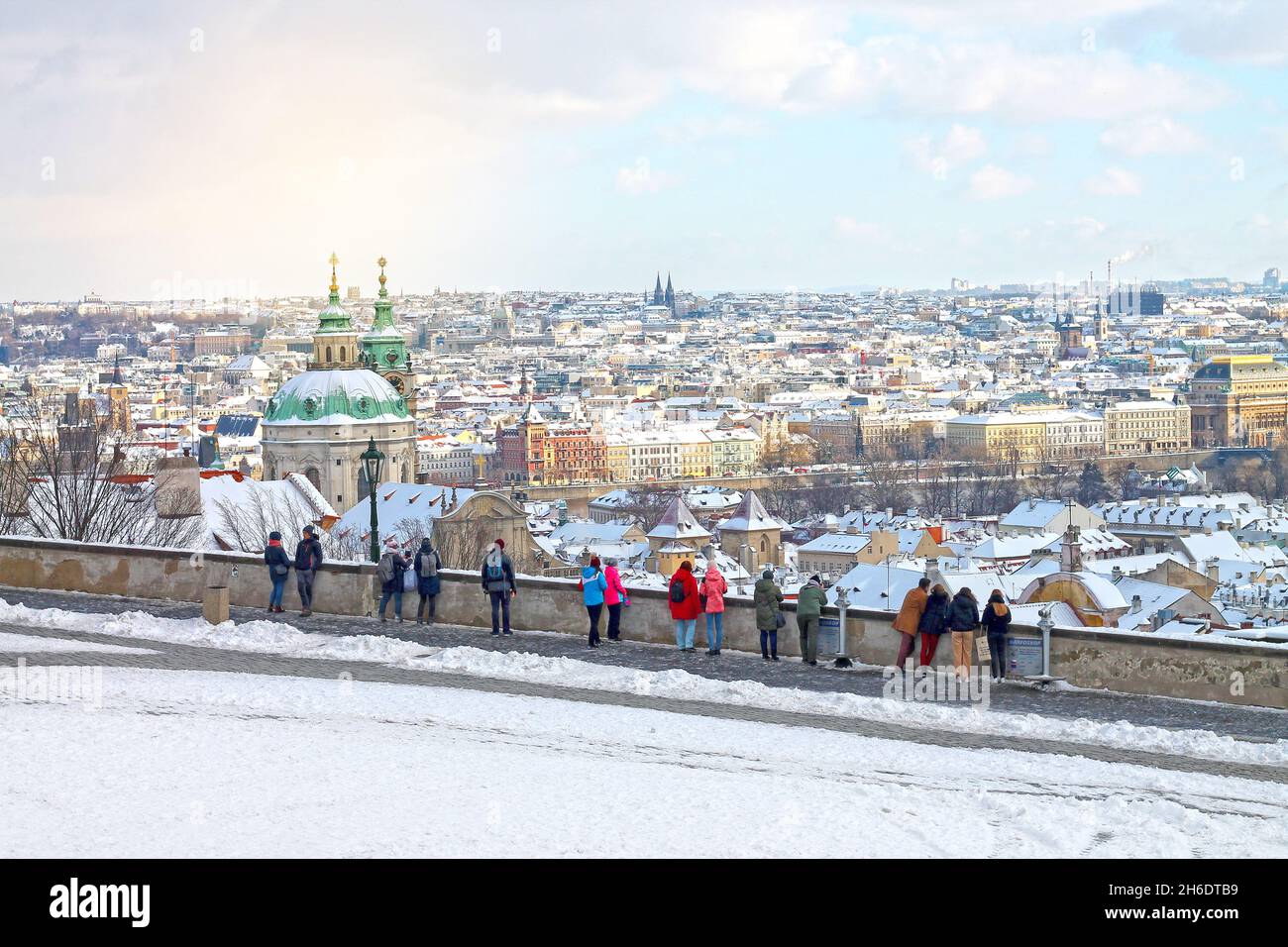 View of winters snowy Prague City, Czech Republic. Christmas time in Prague. Walking tourists see from Hradcany on old part of Prague - Mala Strana. Stock Photo