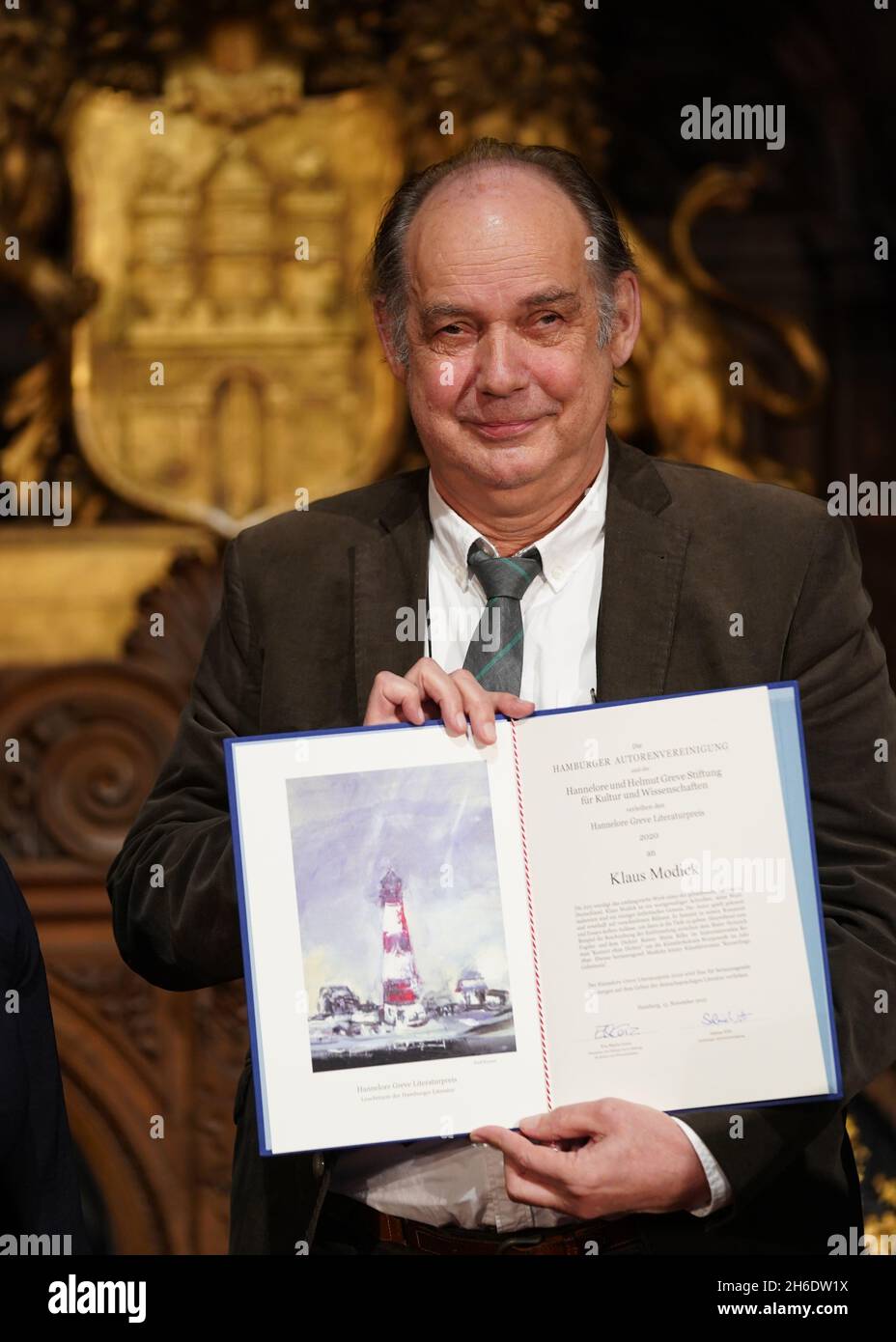 Hamburg, Germany. 15th Nov, 2021. Writer Klaus Modick holds up the ...