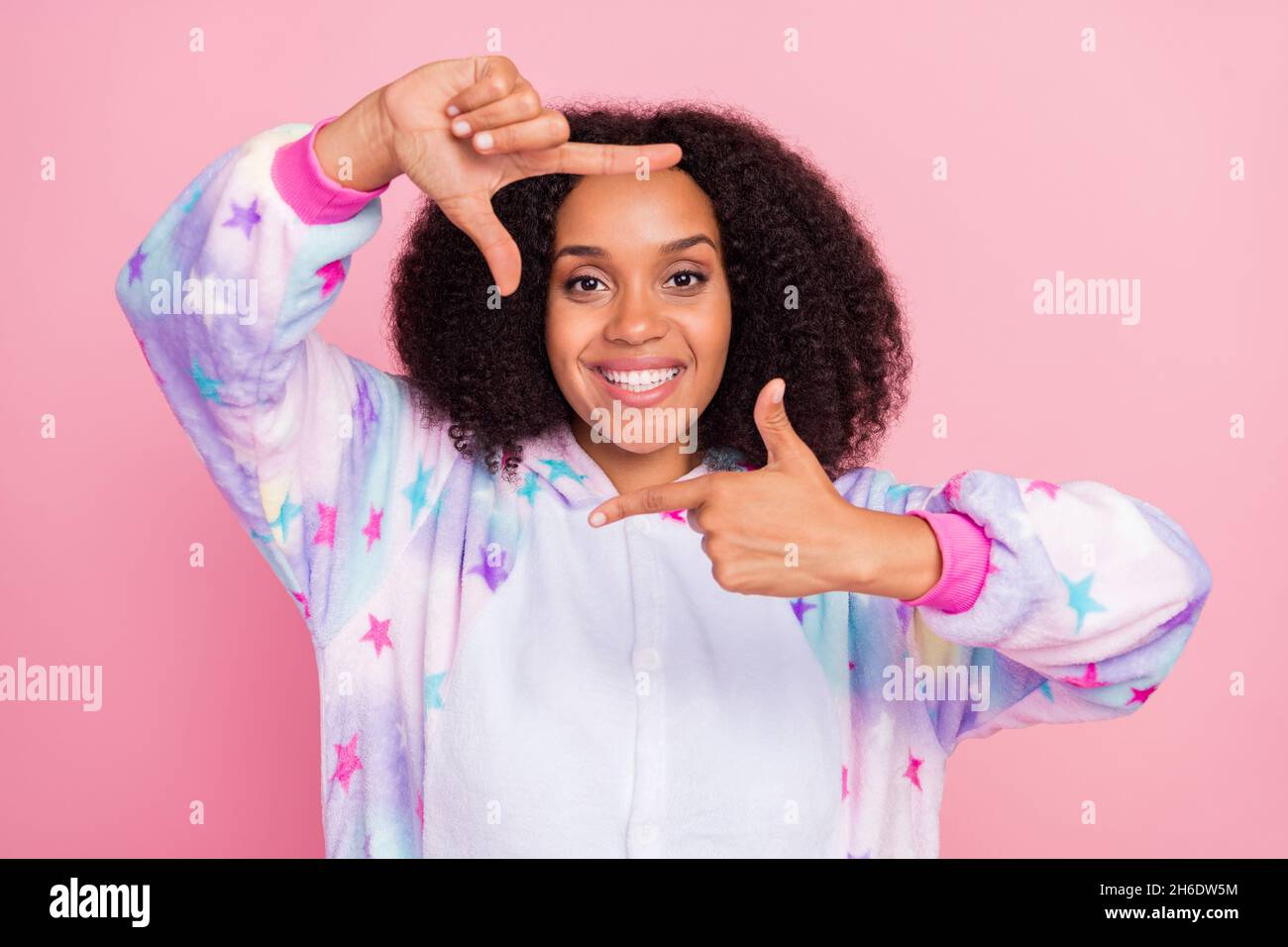 Photo of young afro girl gesture fingers snapshot border portrait perspective isolated over pink color background Stock Photo