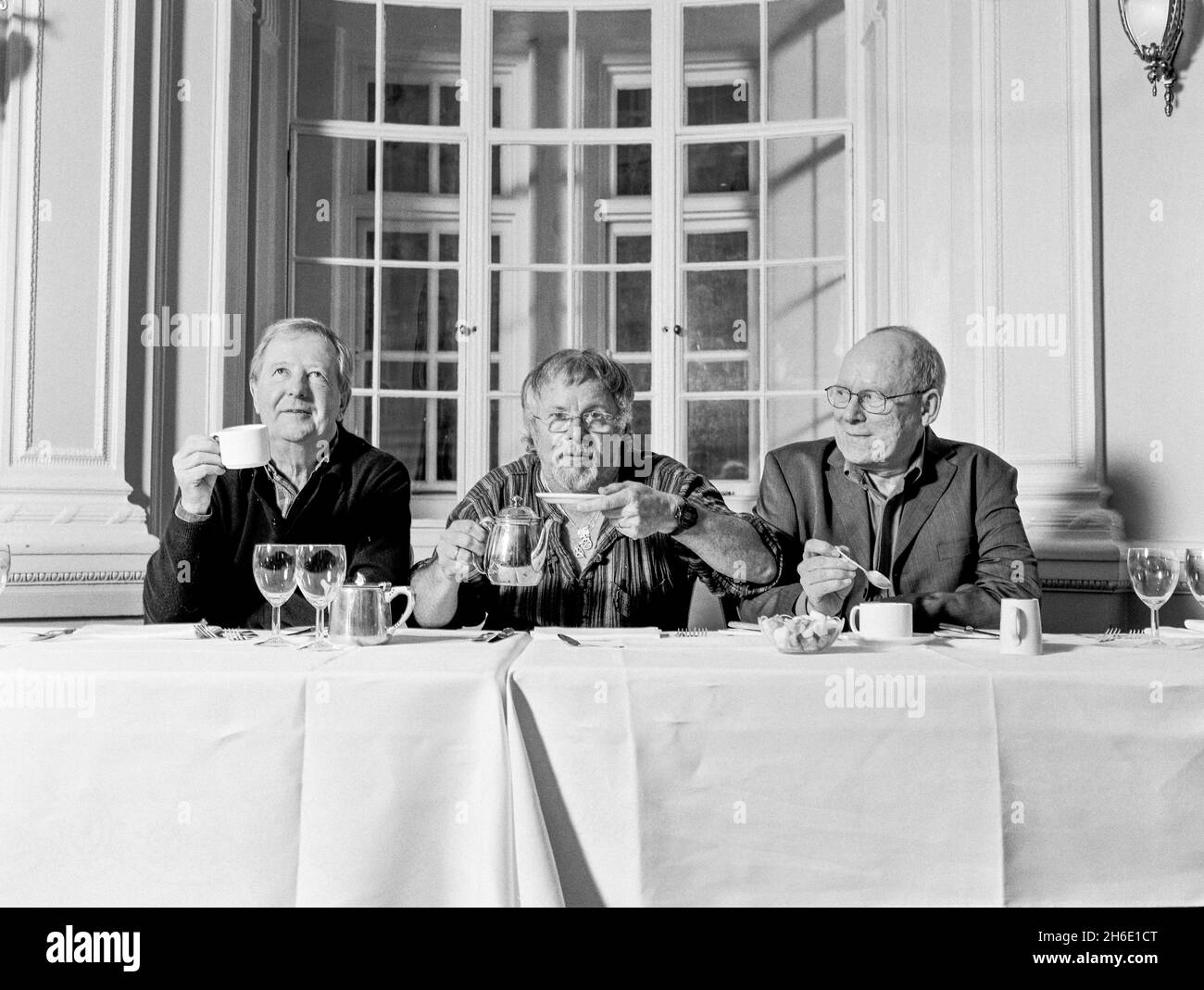 The Goodies classic comedy trio Tim Brooke-Taylor, Graeme Garden and Bill Oddie photographed at Simpsons in the Strand, London, England, United Kingdom. Stock Photo