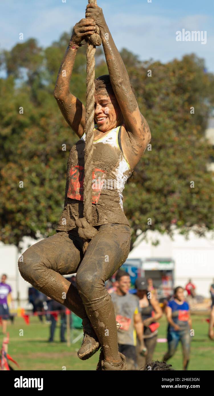 Female athlete competing in the 'Ring the Bell' rope climb  durning the Spartan 'Gladiator Rock'n Run'  5k obstacle course Pasadena, California Stock Photo
