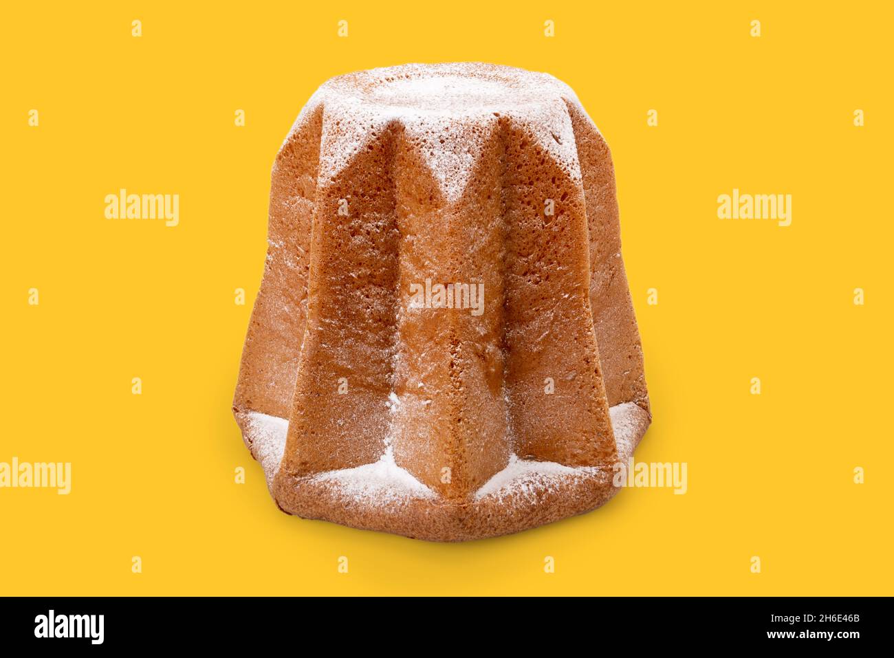 Pandoro, traditional Italian Christmas cake with icing sugar isolated on Yellow Background Stock Photo