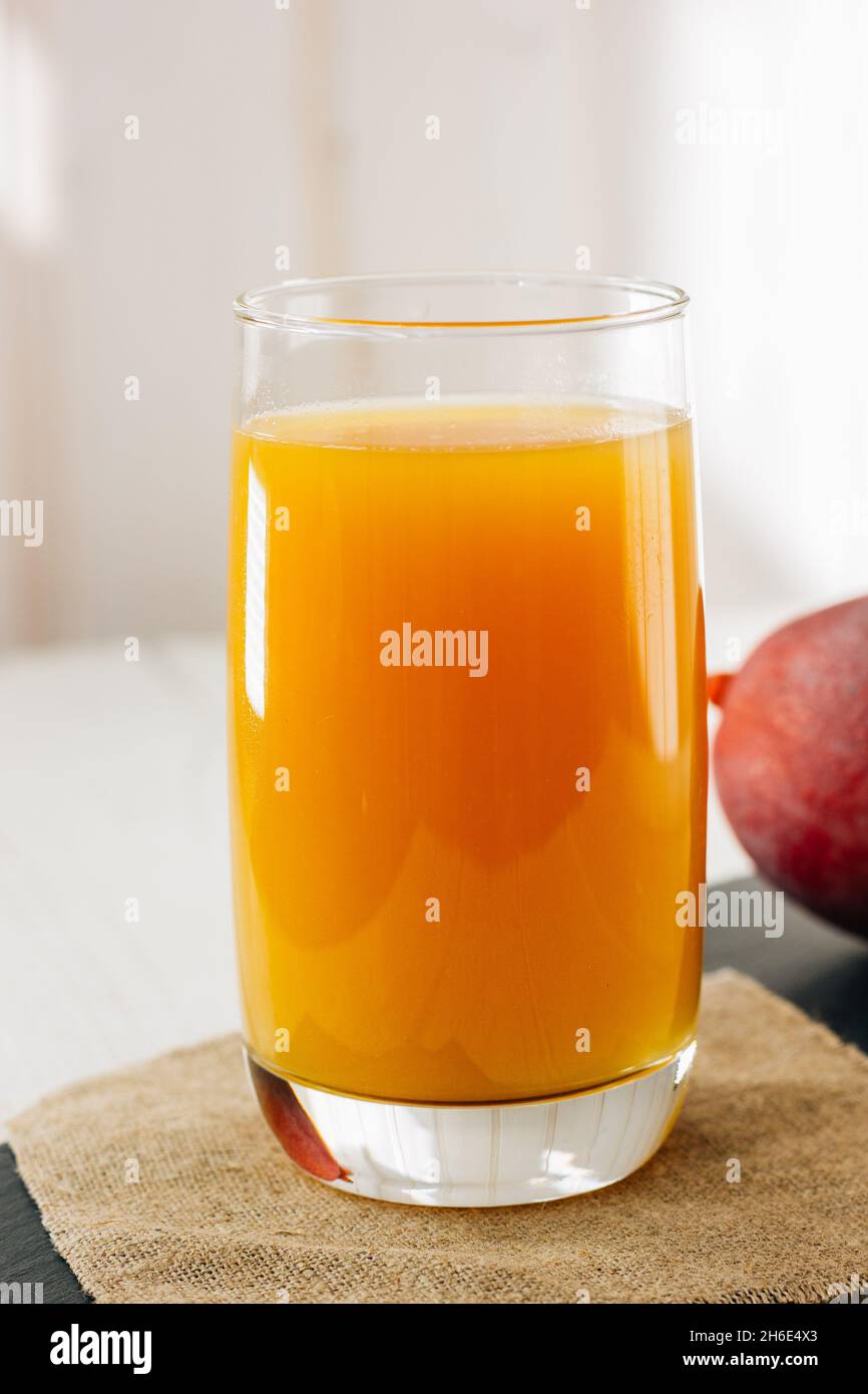 Mango juice in the glass, fresh fruit drink Stock Photo Alamy