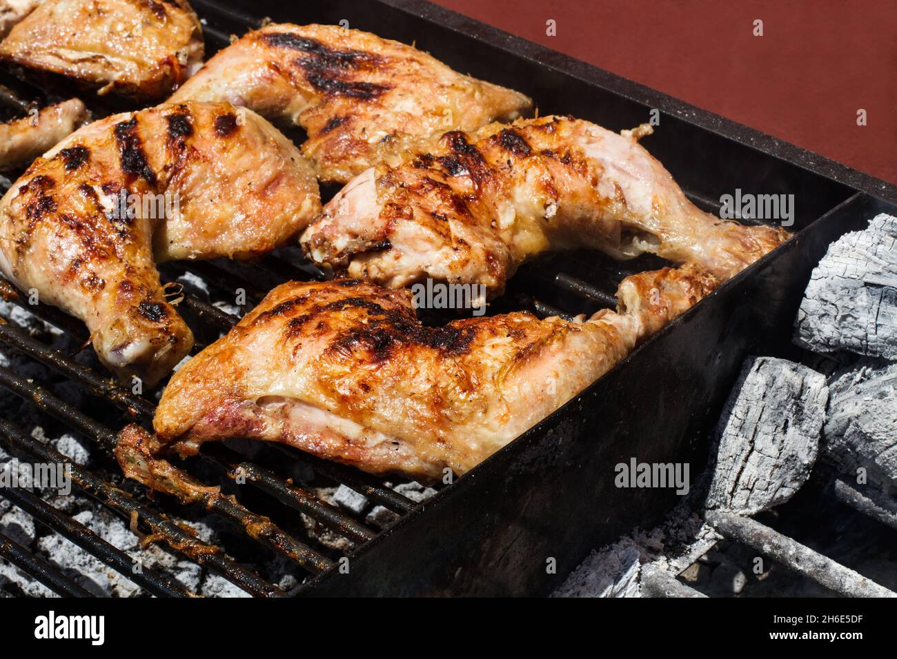 Chicken legs and thighs on the woodfired grill Stock Photo Alamy