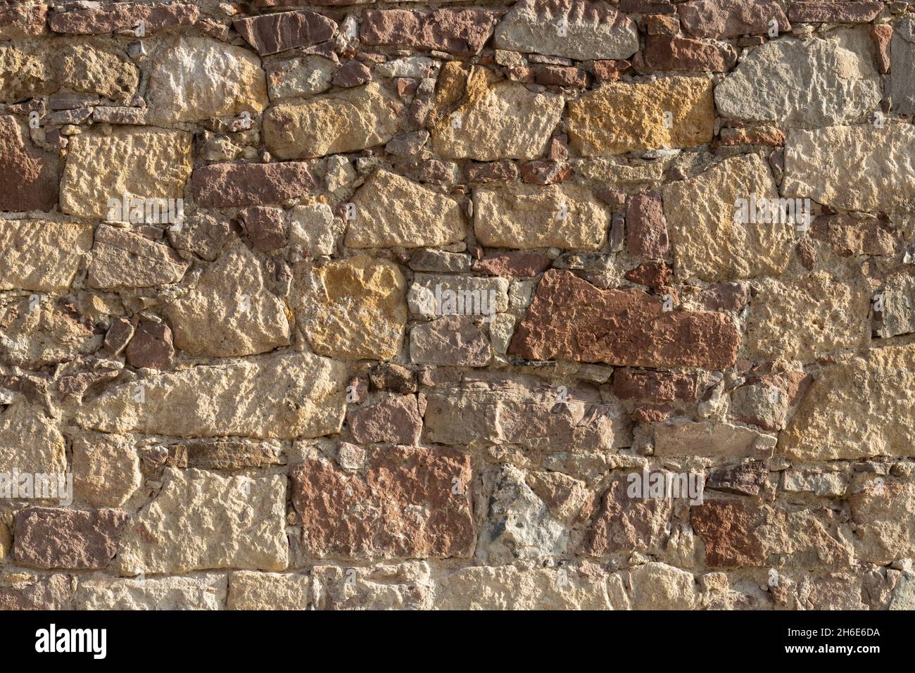 Historic stone wall. Texture of a stone wall. Old castle stone wall texture background. Stock Photo