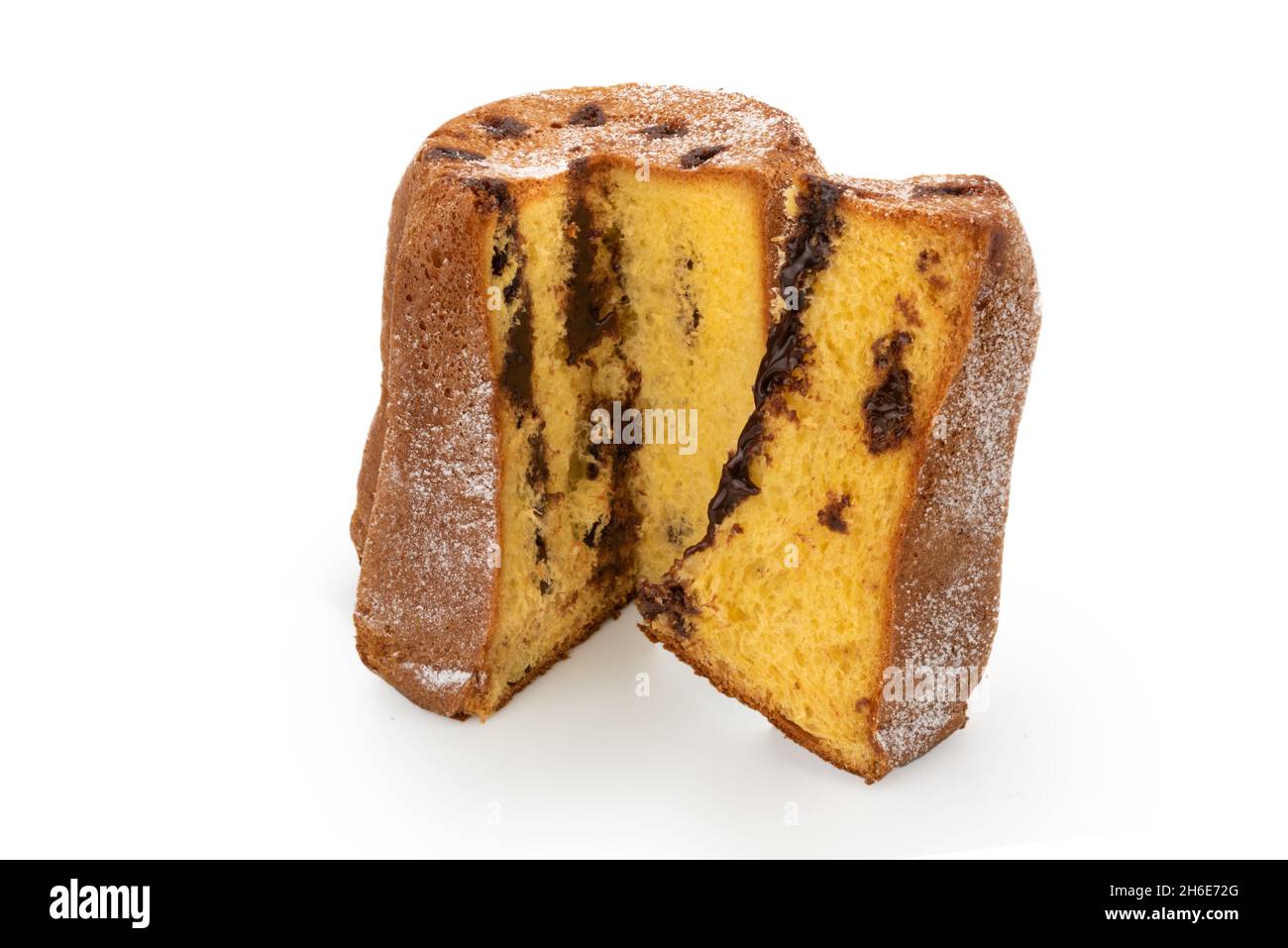 Pandoro filled with cream chocolate cut with slice, traditional Italian Christmas cake with icing sugar isolated on white Stock Photo