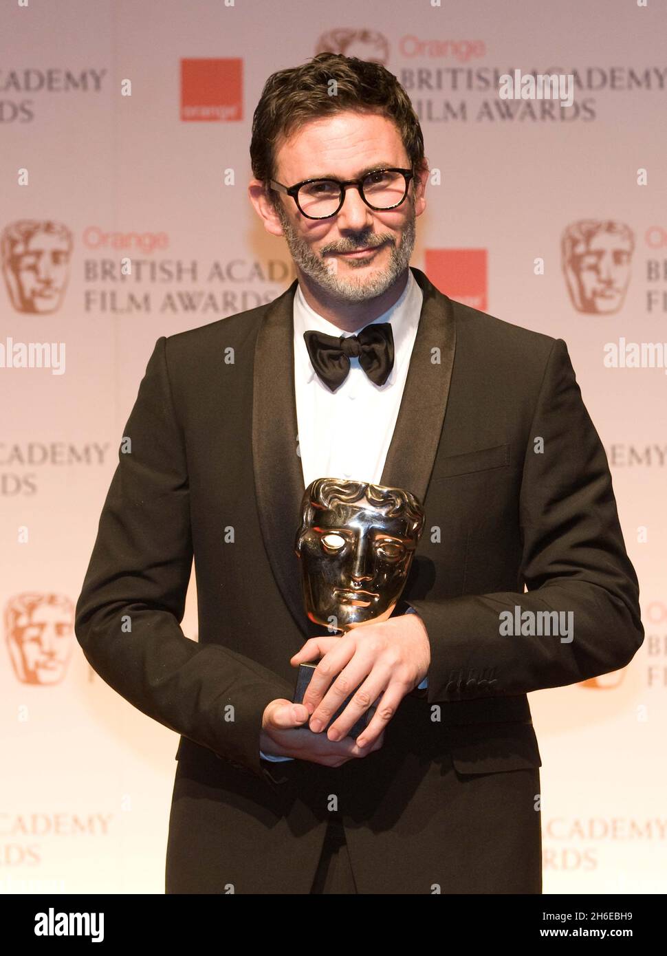 Michel Hazanavicius accepting the Best Cinematography Award on behalf of Guillaume Schiffman poses in the press room at the Orange British Academy Film Awards 2012 at The Royal Opera House Stock Photo