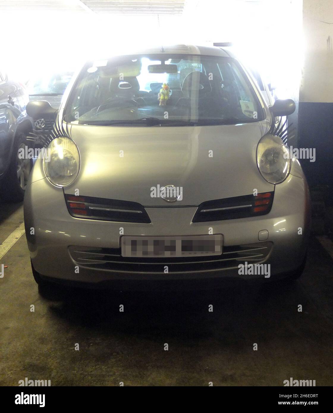 Cars with eyelashes in a car park in Walthamstow, East London Stock