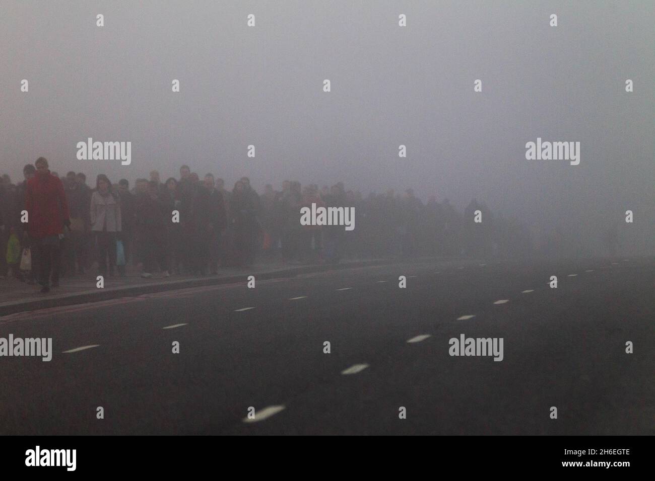 Commuters on London bridge during thick fog in central London this ...