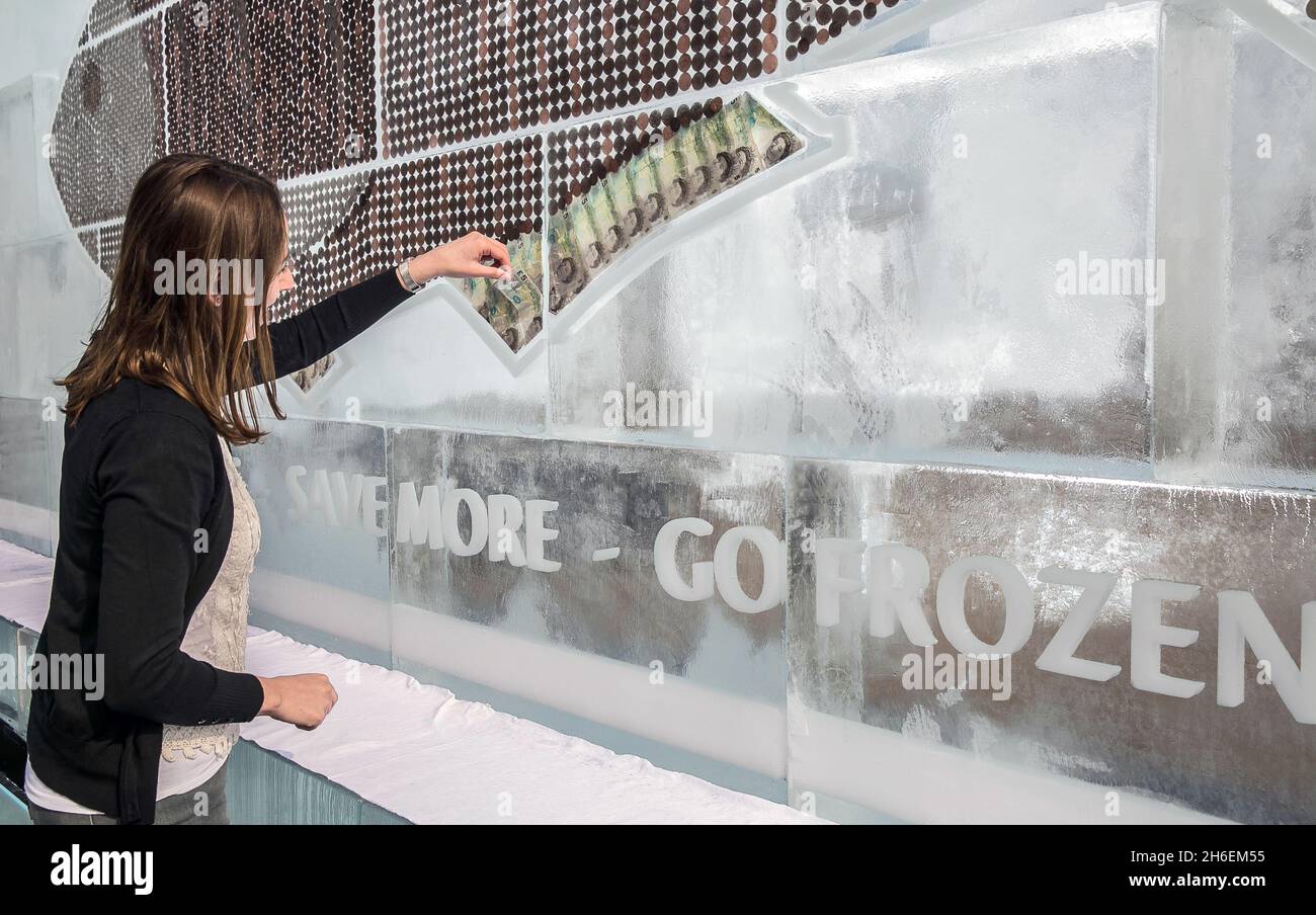 A 20-foot frozen billboard made entirely of ice and cash was unveiled today to urge Brits to save money and reduce household waste by using their freezer more. The billboard containing Ã‚Â£700 in coins and notes (the amount the average household wastes every year on food) was created by iFreeze, iSave and follows research revealing that two million Brits keep money in the freezer but throw away 850,000 tonnes of good food every year. Stock Photo