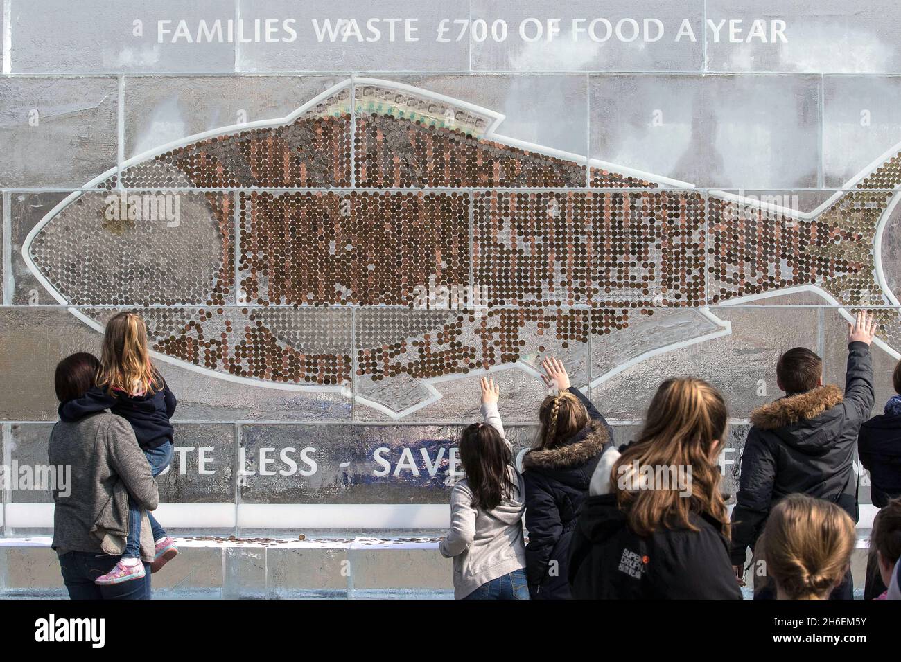 A 20-foot frozen billboard made entirely of ice and cash was unveiled today to urge Brits to save money and reduce household waste by using their freezer more. The billboard containing Ã‚Â£700 in coins and notes (the amount the average household wastes every year on food) was created by iFreeze, iSave and follows research revealing that two million Brits keep money in the freezer but throw away 850,000 tonnes of good food every year. Stock Photo
