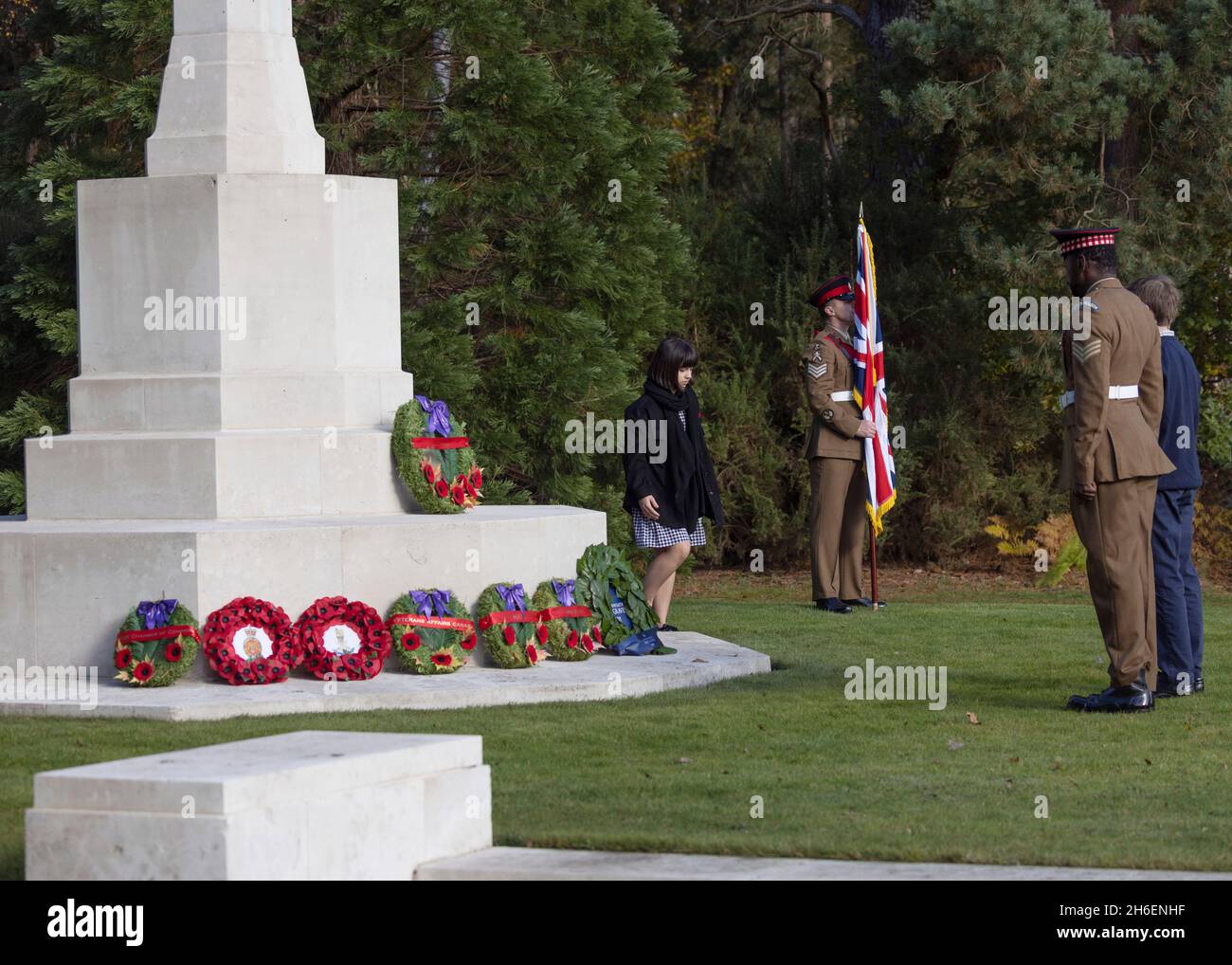 A female student lays a wreath at the Canadian Cross of Sacrifice in the CWGC military cemetery at Brookwood Surrey on 11th November 2021 Stock Photo