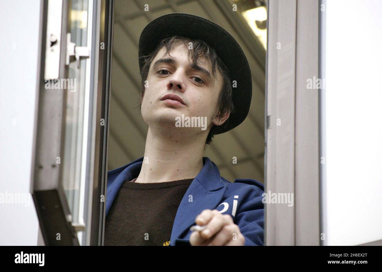 Singer Pete Doherty appears at the window of Thames Magistrates court in London today as he awaits his court hearing for drugs charges . Stock Photo