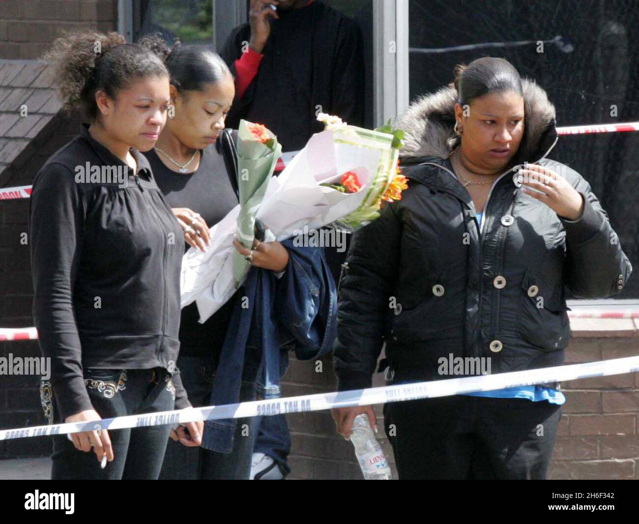Friends of the victim laying flowers at the murder scene in Mann Close ...