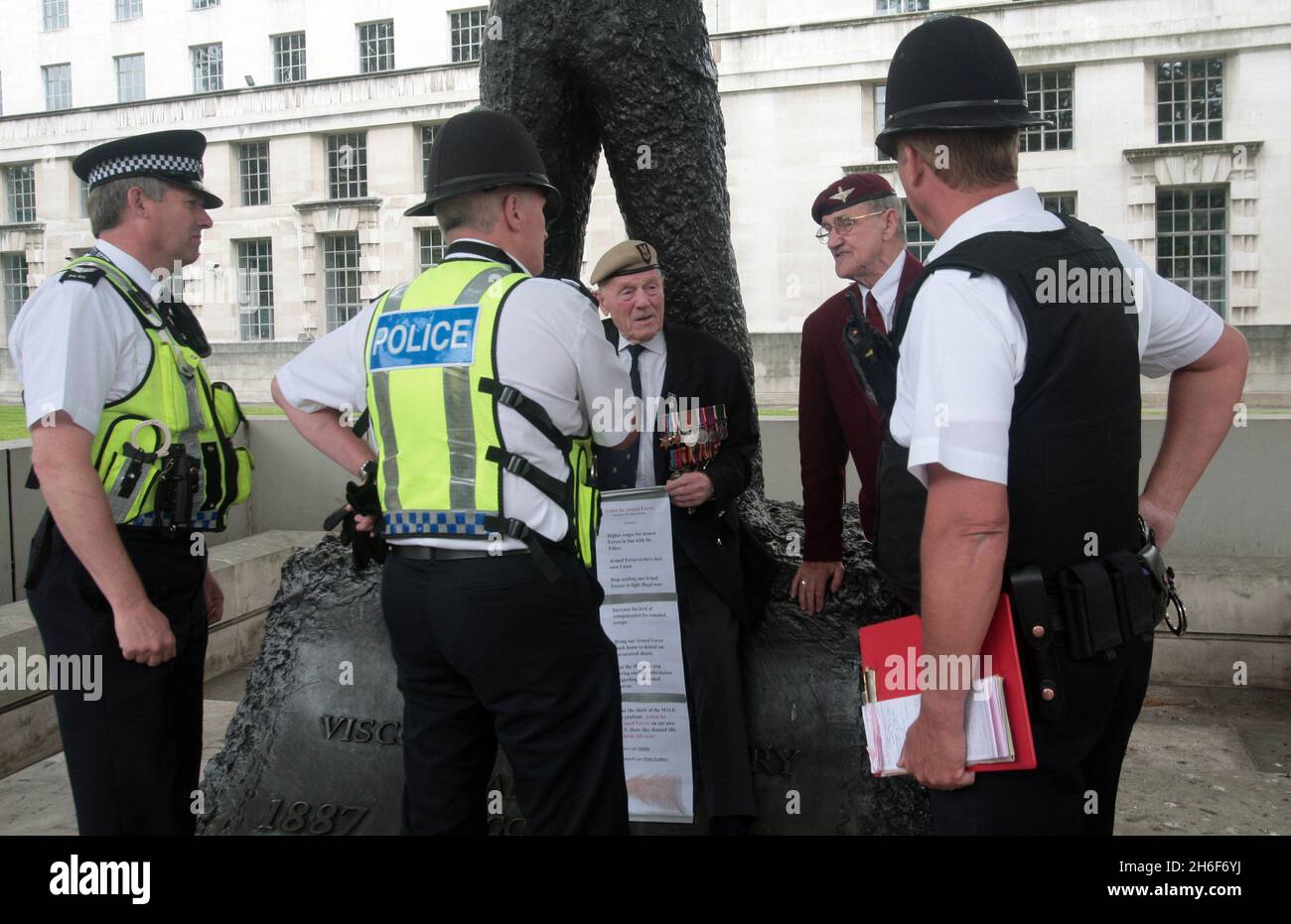 Army War Veterans - 88 year old George Kay and 74 year old Ricky Clitheroe chain themselves to the statue of Field Marshal Montgomery outside the MOD in central London. The pair, who chained themselves to the gates of Buckingham Palace last month, are continuing their fight for more rights and recognition of British troops serving in Iraq and Afghanistan. Stock Photo