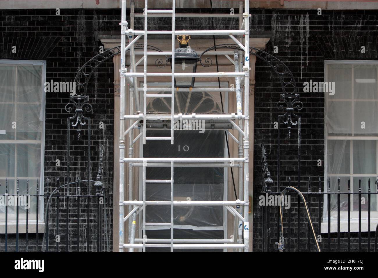 A plastic sheet covers the front door of No.10 Downing Street today as