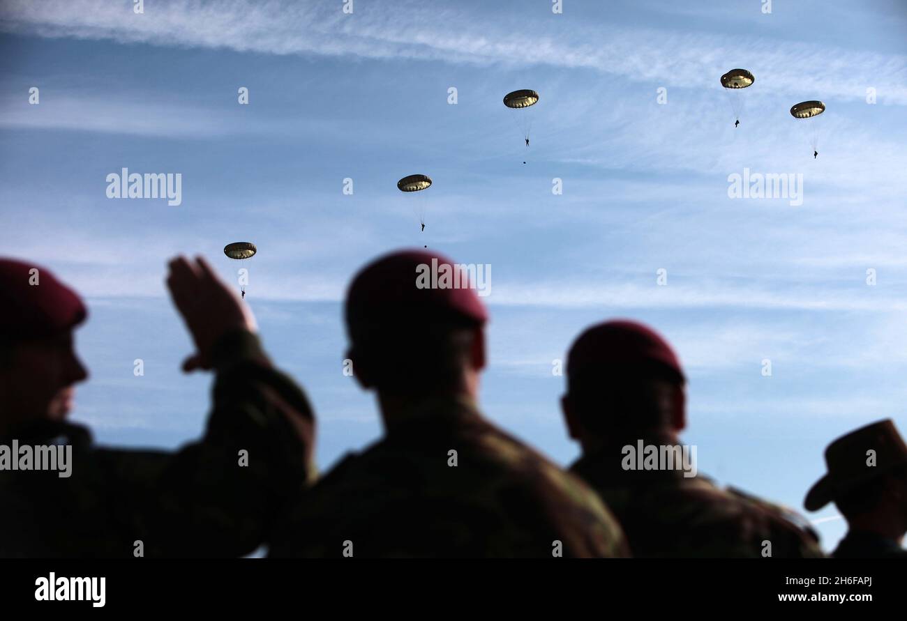 The Parachute Regiment made a memorial parachute jump near Ranville in France this morning in honour of the WWII veterans who jumped on 6th June 1944 and liberated Ranville . Picture shows: Members of the 3rd Battalion parachute regiment watching their colleague jump. Stock Photo