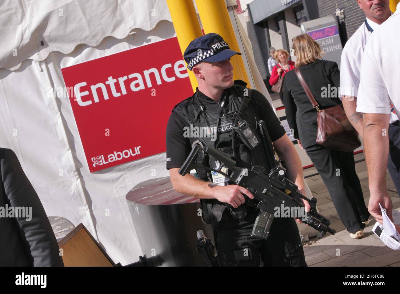 An armed police office is pictured outside the entrance to the Labour Party Conference in Brighton Stock Photo