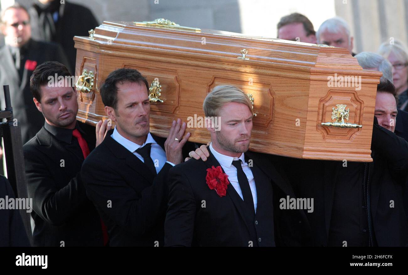 Band members including Ronan Keating carry the coffin of Stephen Gately from the Church of St Laurence O'Toole in Dublin after the funeral of the Boyzone singer who died of natural cause last weekend aged 33. Stock Photo