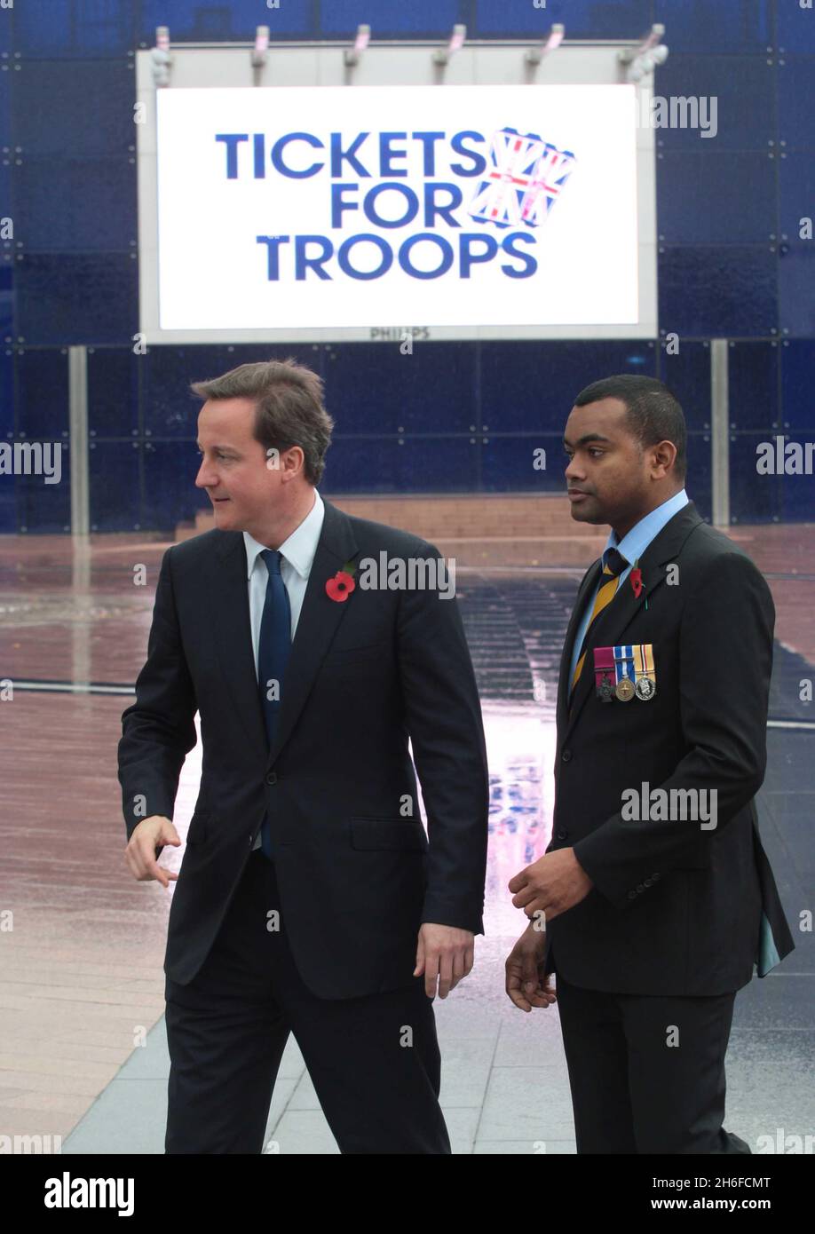 Conservative leader David Cameron launches his Tickets for Troops scheme encouraging promoters of music concerts and sporting events to give free tickets to soldiers. Picture shows: David Cameron with soldier Johnson Beharry Stock Photo