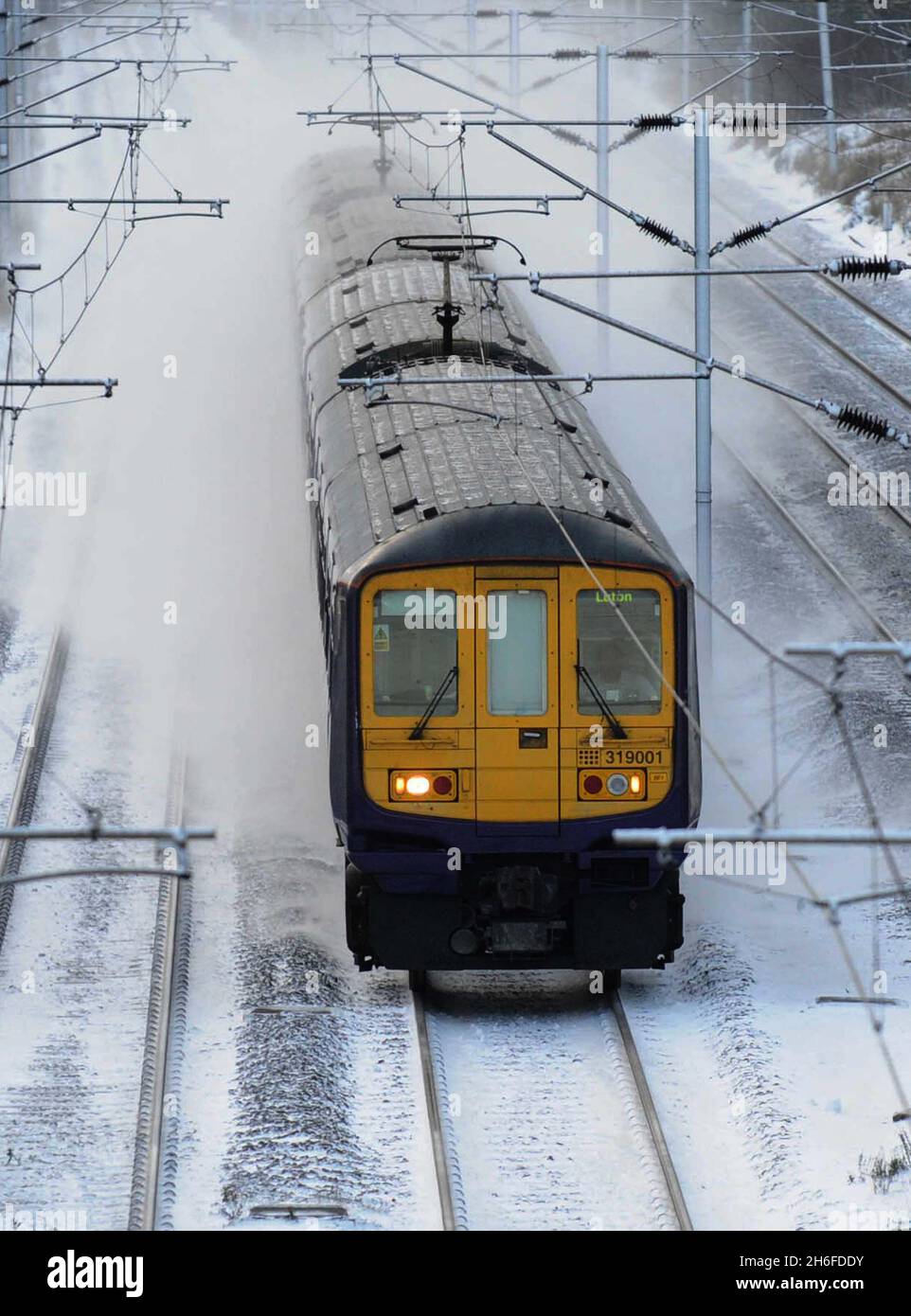 A commuter train in the snow in North London this morning Stock Photo