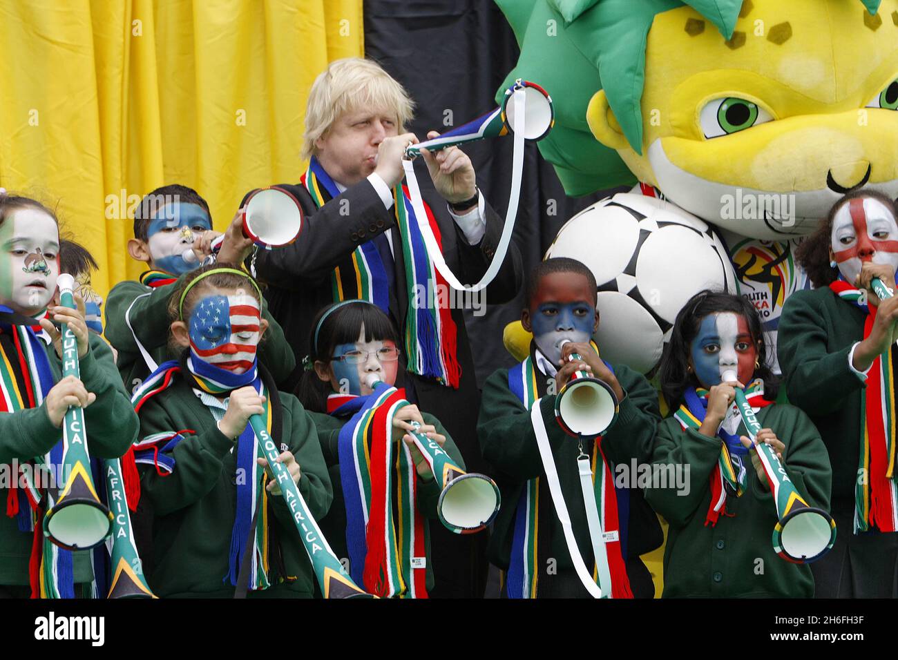 The Mayor of London Boris Johnson welcomes the start of the Fifa World Cup by blowing vuvuzelas with local children in Trafalgar Square, London Stock Photo