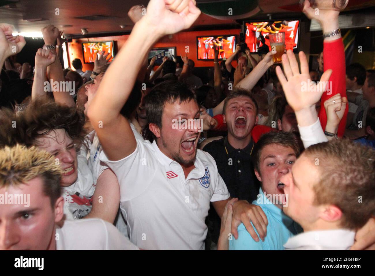 England football fans celebrate England's first goal at The Sports Cafe in London's Haymarket this afternoon Stock Photo