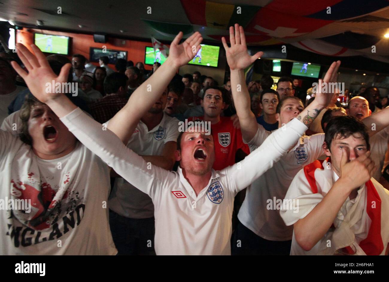 England football fans celebrate England's first goal at The Sports Cafe in London's Haymarket this afternoon Stock Photo