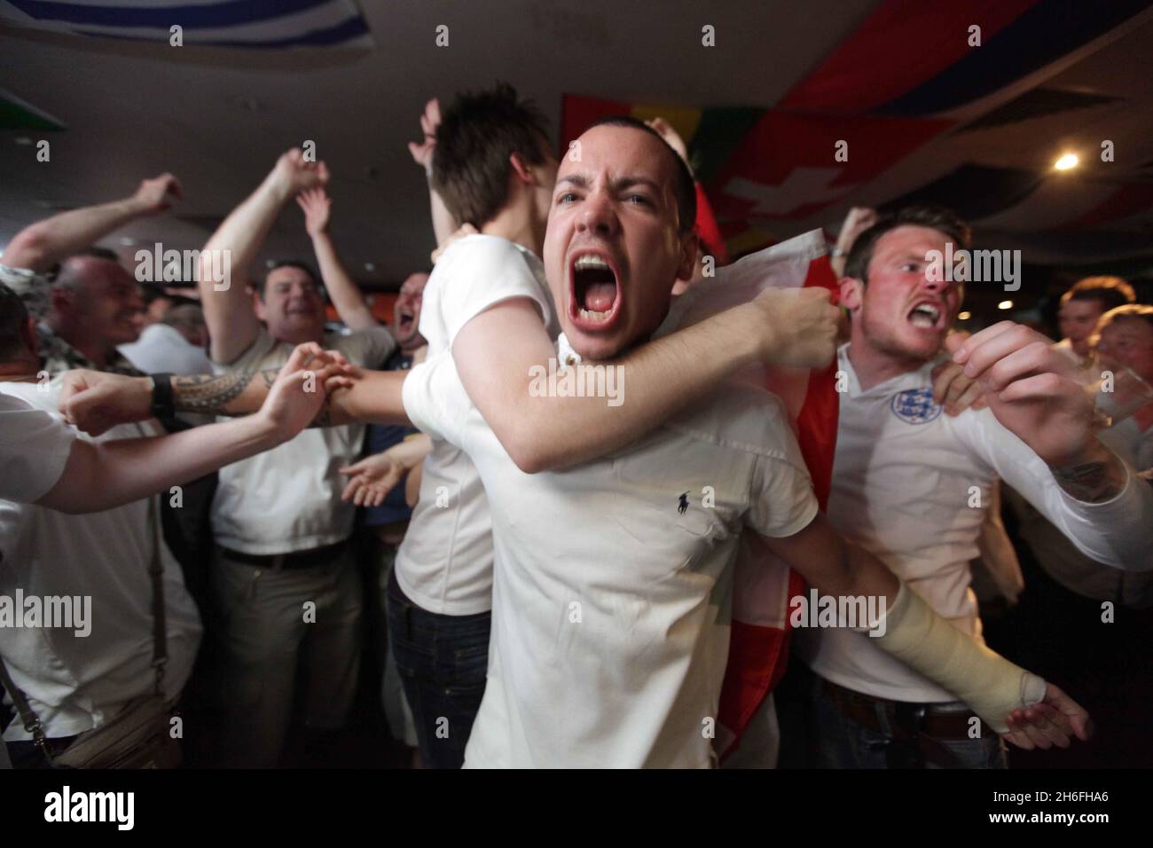 England football fans celebrate at The Sports Cafe in London's Haymarket this afternoon after England beat Slovenia in the World Cup Stock Photo